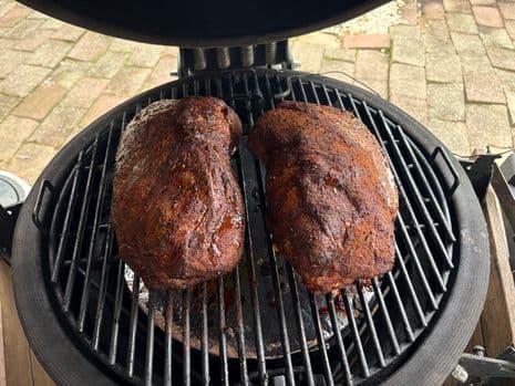 Twee gekruide procureurs worden bereid tot pulled pork op een kamado barbecue