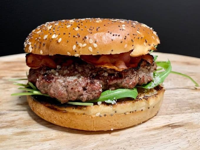 een Italiaanse picanha burger op een broodje met bacon en sla